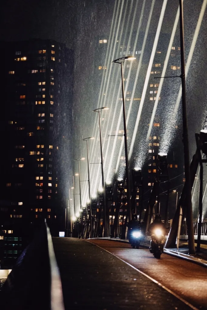Illuminated high-rise facade at night, seen along its length