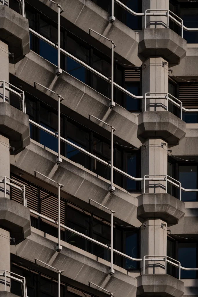 Concrete facade with angular balconies and white railings stepping diagonally down the building